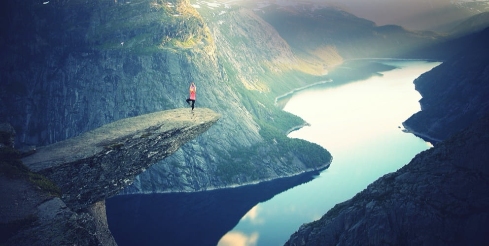 Hero image of woman sitting on cliff